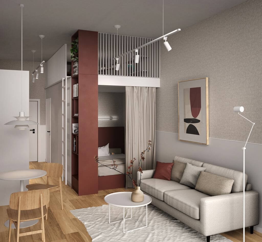 Nowoczesny apartament typu studio z przytulnym salonem z jasnoszarą sofą, okrągłym białym stolikiem kawowym i minimalistycznym wystrojem. Łóżko piętrowe z zasłoną zapewniającą prywatność jest wbudowane w czerwoną konstrukcję, a także jest mała jadalnia z drewnianymi krzesłami. Dominują neutralne tony.